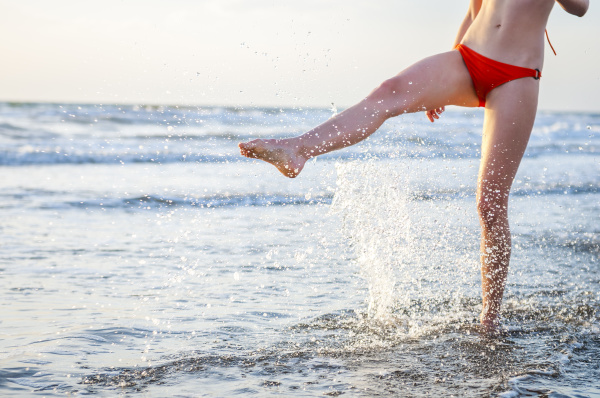 legs of a woman splashing with