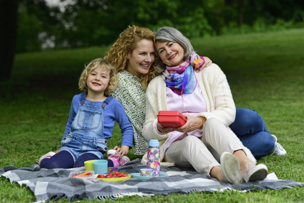 happy three generation females enjoying picnic