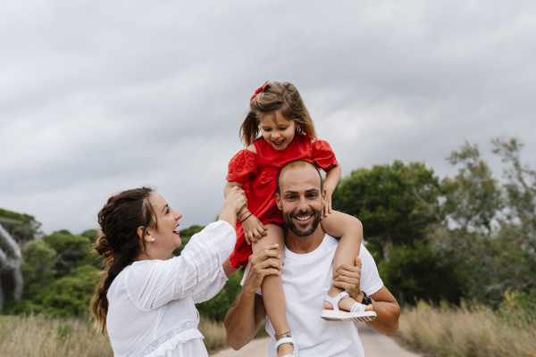 cheerful family enjoying at countryside against