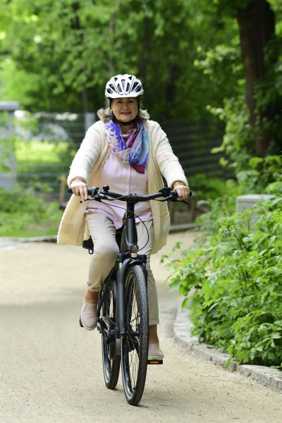 smiling senior woman riding electric bicycle
