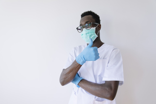 afro doctor wearing surgical mask showing