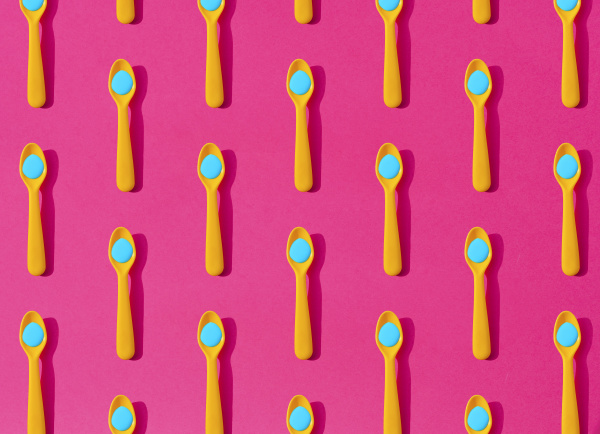 seamless pattern ofyellow plastic teaspoons with