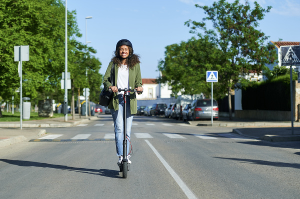 happy young woman riding electric push