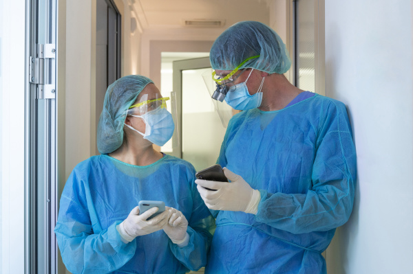 male and female dentists discussing while
