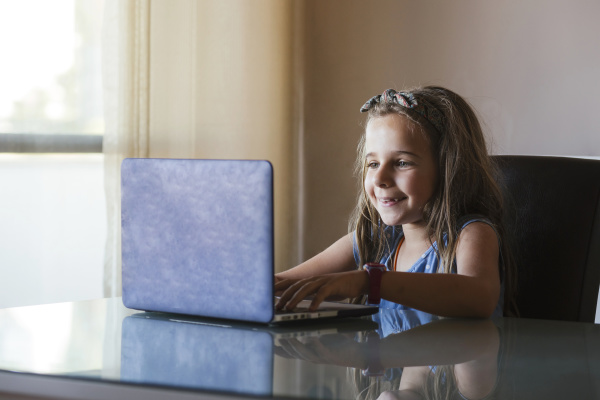 girl using laptop at home