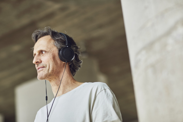 senior man with headphones listening music