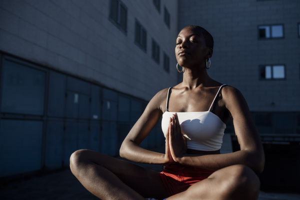young woman with eyes closed meditating