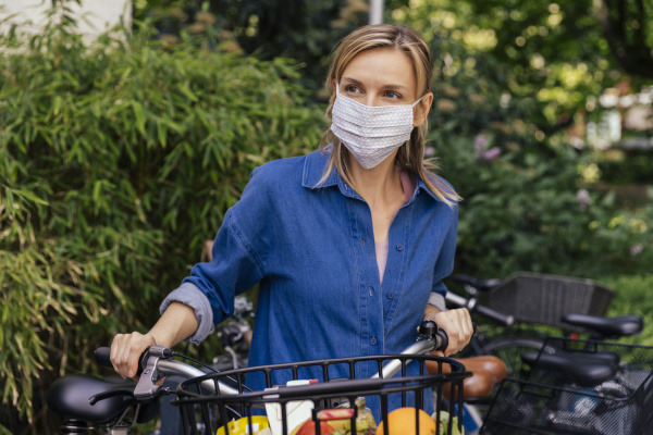 woman wearing face mask with bicycle