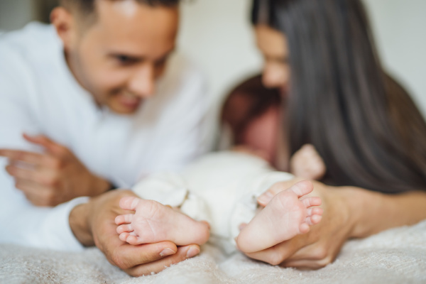 parents holding baby boy s feet