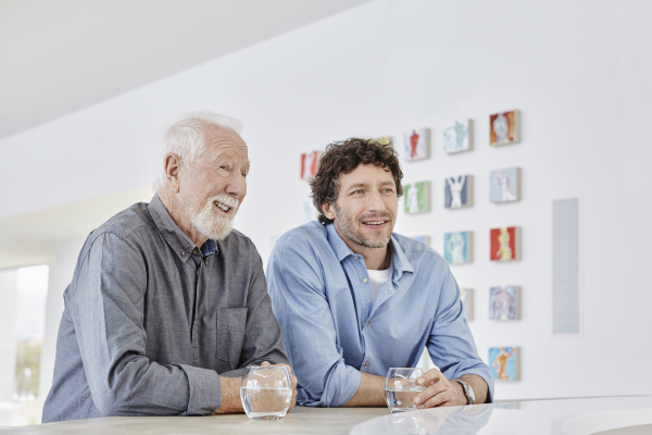 smiling senior man with adult son
