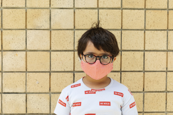boy wearing red mask in front