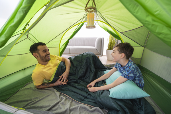 father and son in tent at