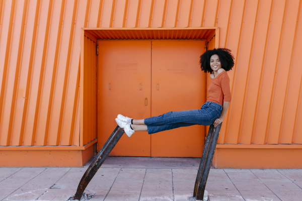 smiling young afro woman sitting on