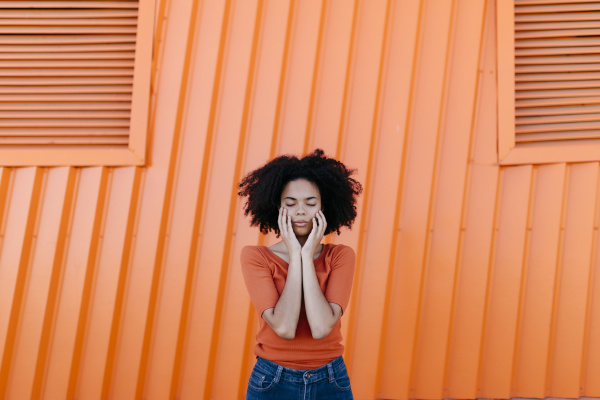 young afro woman with eyes closed