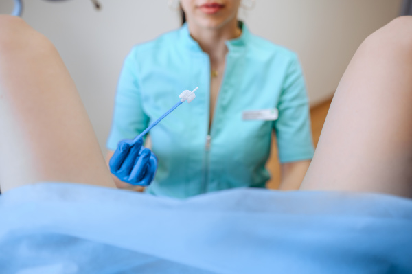 female gynecologist holds cotton tampon
