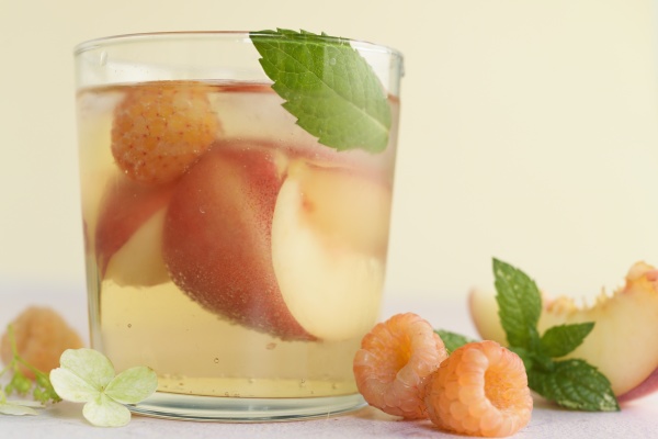 peach cocktail with fresh raspberries