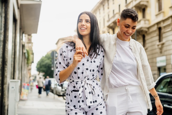 young lesbian couple walking arm in
