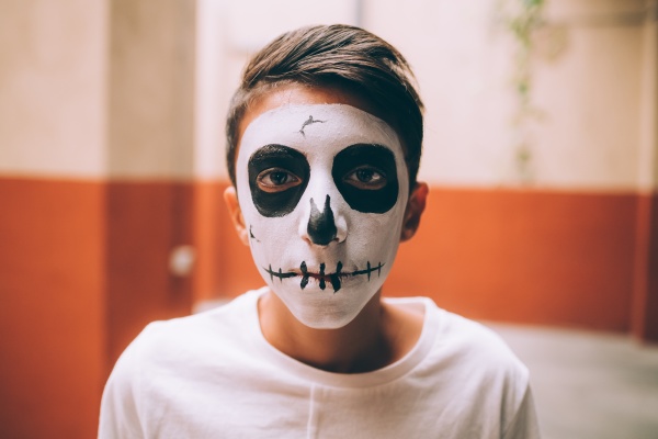boy with halloween skull face paint