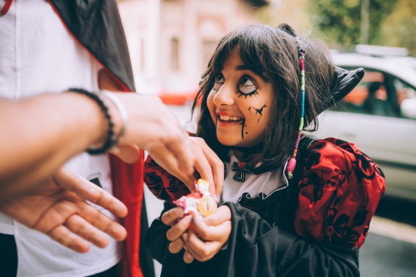 girl in halloween costume trick