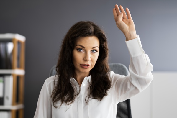woman raising hand in video conference
