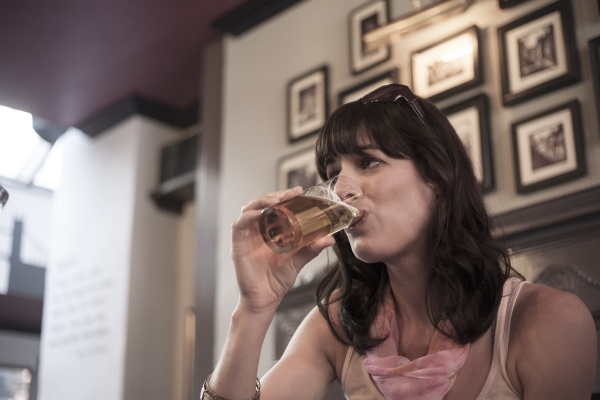 woman looking away while drinking beer