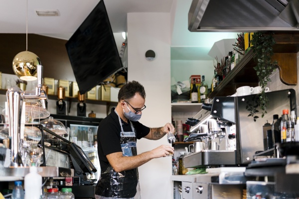 male barista wearing protective face mask