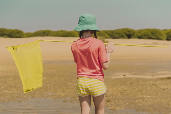 girl with yellow fishing net standing