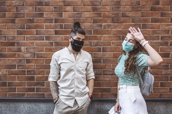 couple wearing protective face masks while