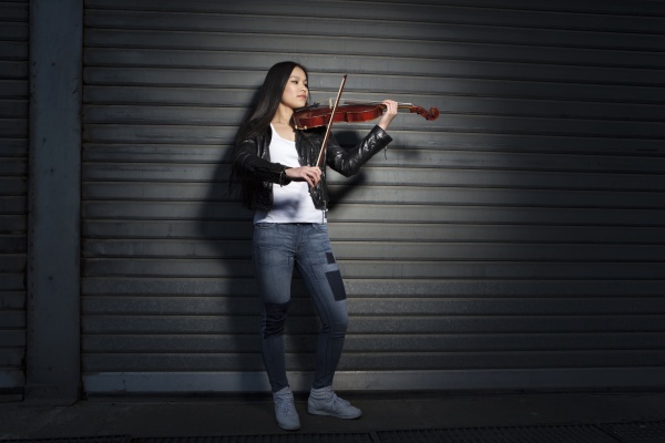 young female asian playing violin in