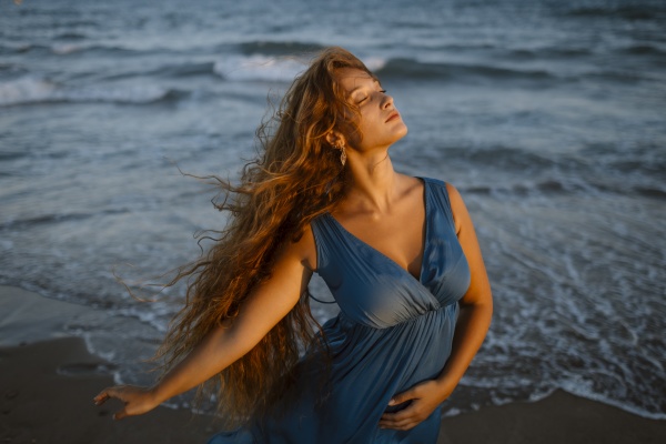 beautiful woman dancing at beach during