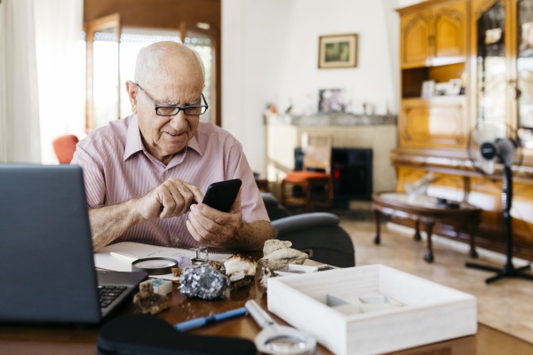 elderly man using smart phone while