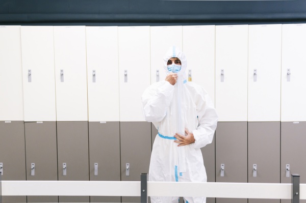 healthcare man standing against locker in