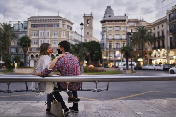 couple sitting on bench in city