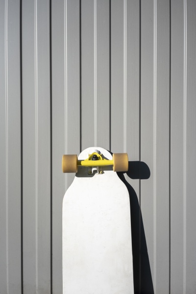skateboard against metal wall