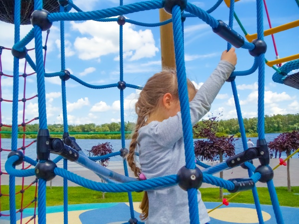girl climbing in adventure rope park