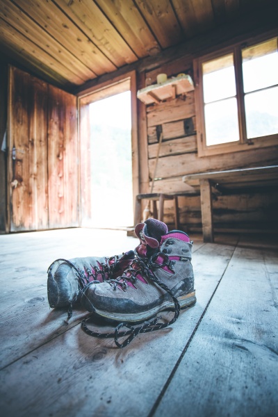 alpine boots on rustic wood floor