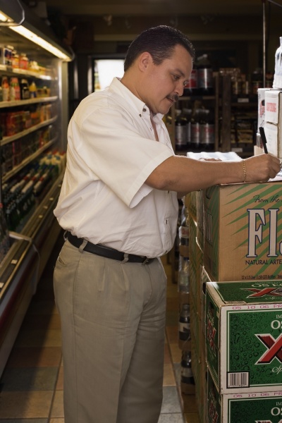 small businessman taking inventory of grocery