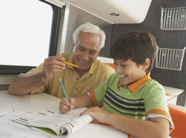 senior man teaching his grandson and