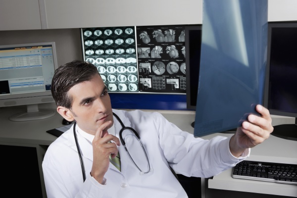 doctor examining an x ray report