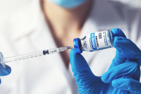 doctor preparing covid 19 vaccine dose