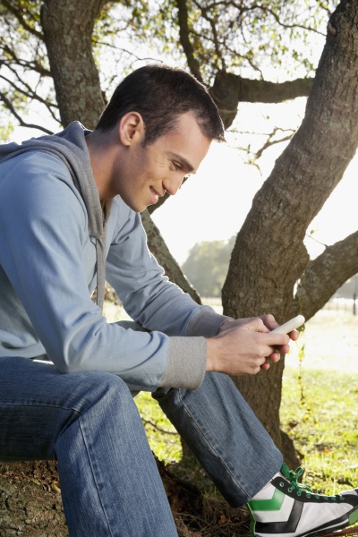 man text messaging on a mobile