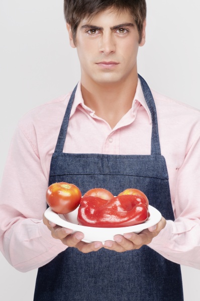 man holding a plate of red