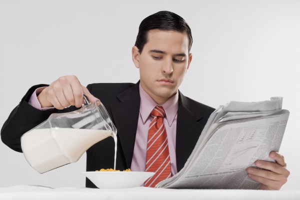 businessman pouring milk into a bowl