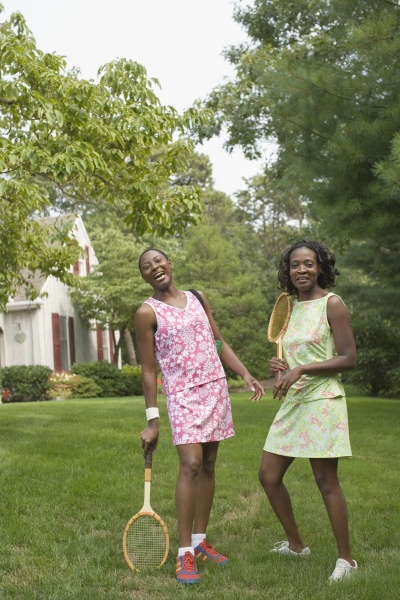 two mid adult women holding tennis