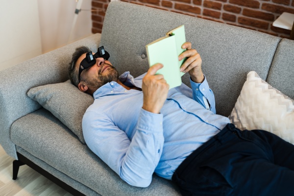 man using lazy reading prism glasses