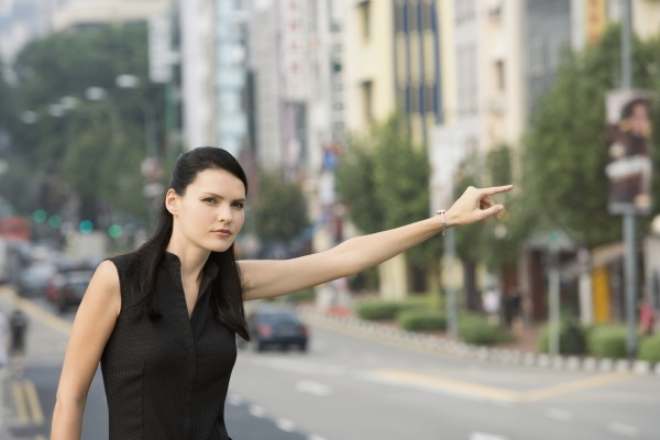 businesswoman hailing for a vehicle