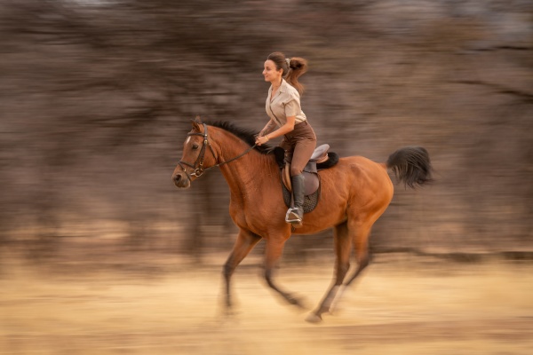 slow pan of brunette riding past
