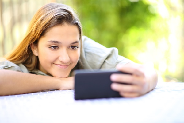 satisfied woman watching videos on smart