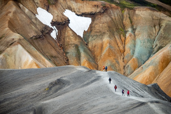 hikers in volcanic mountains of landmannalaugar