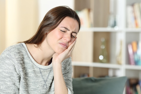 woman suffering toothache at home